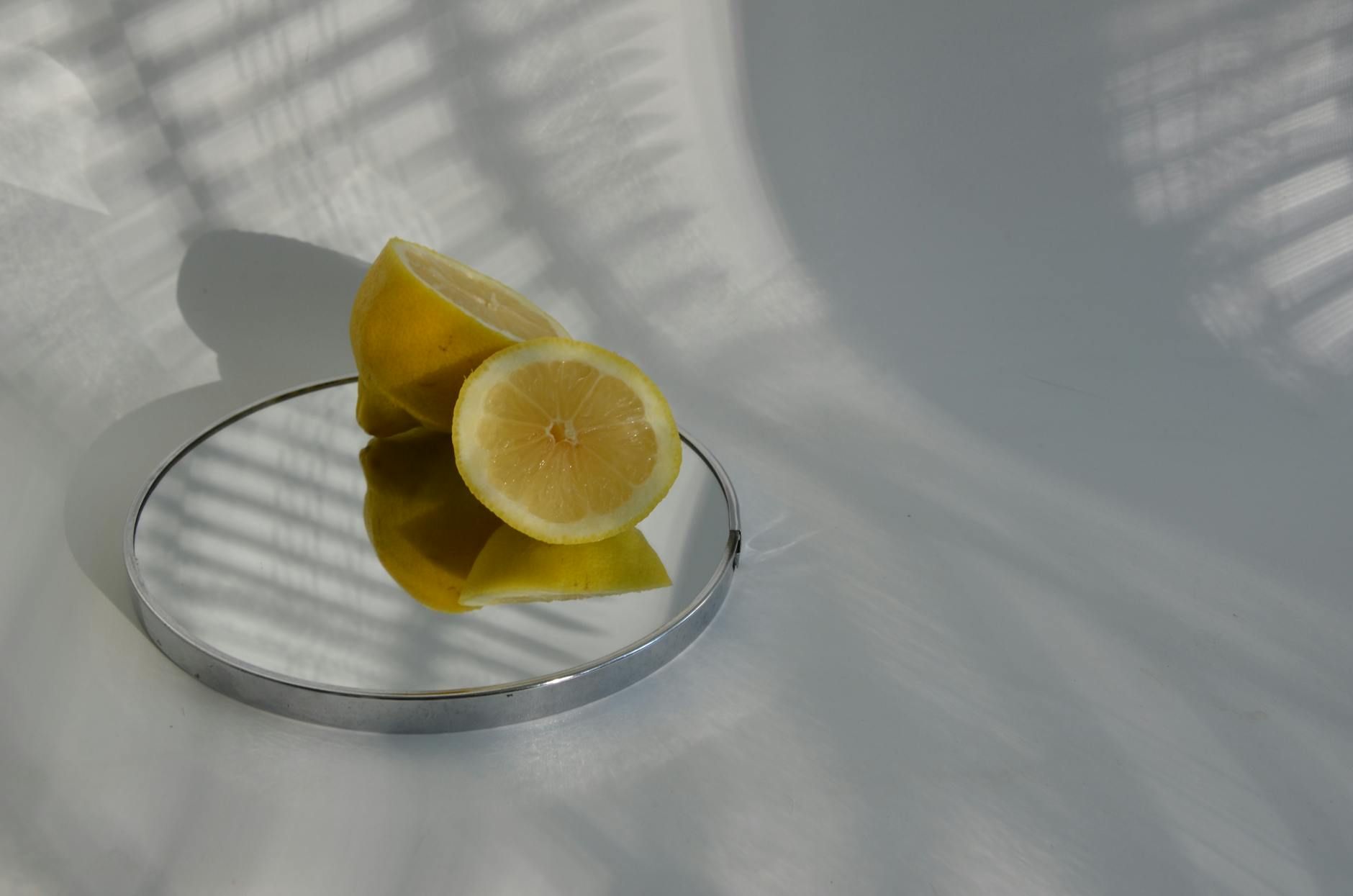 Hands holding a sleek blue lemon vibrator against a purple background